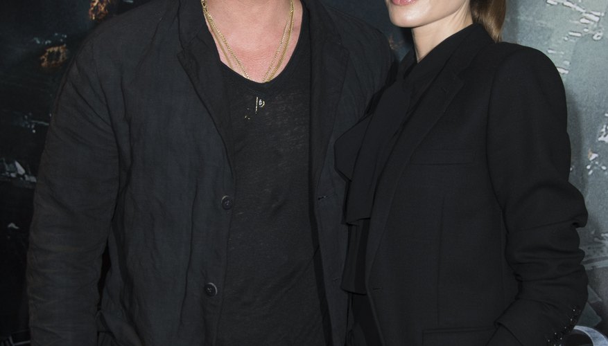 Angelina Jolie and Brad Pitt stop for photographers before entering a 2013 movie premiere.