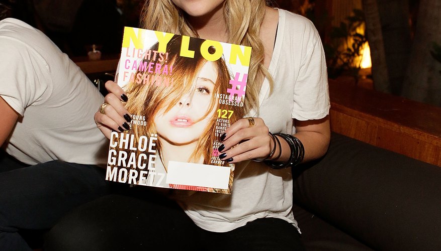Actress Ashley Benson celebrates NYLON in a black beanie.