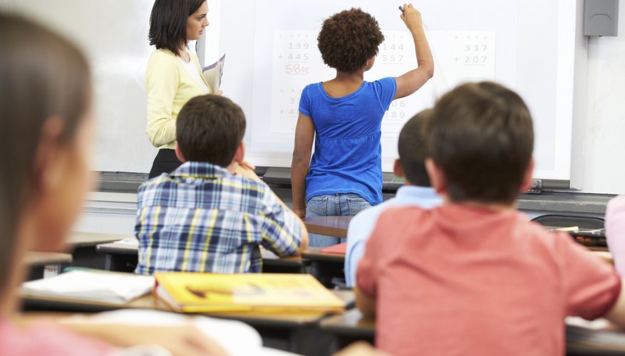 Teacher working with students in classroom