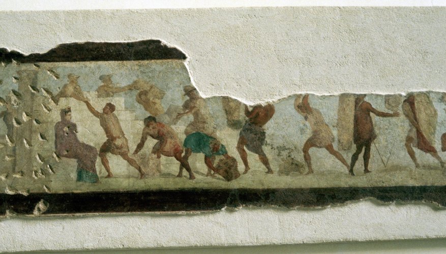 A mural fragment shows slaves building a wall in ancient Rome
