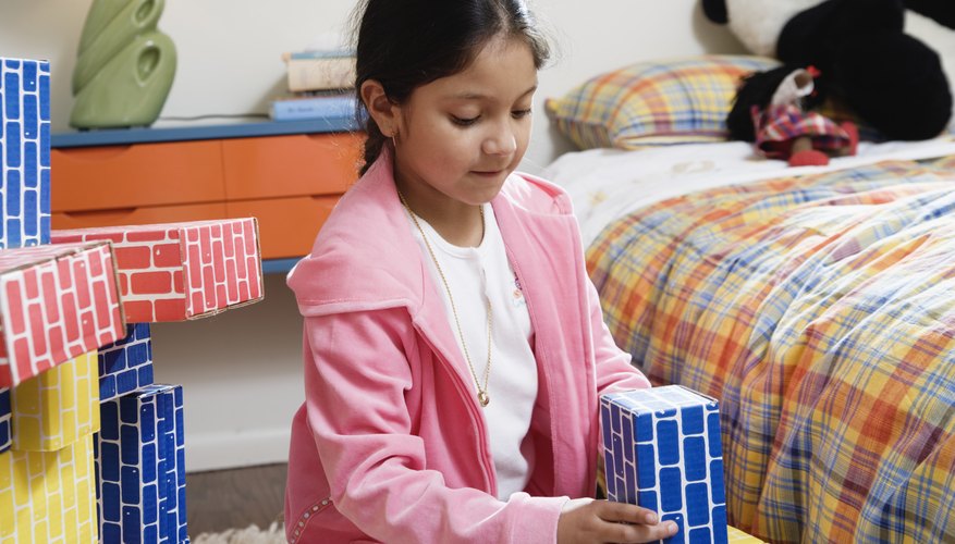 Child playing with blocks in bedroom.