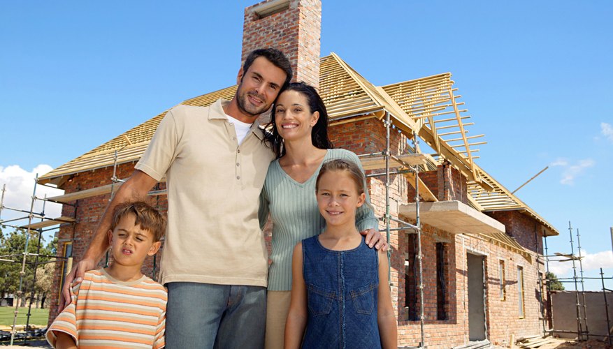 family infront of home being built