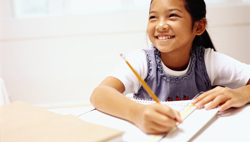 Fifth grade student writing in notebook