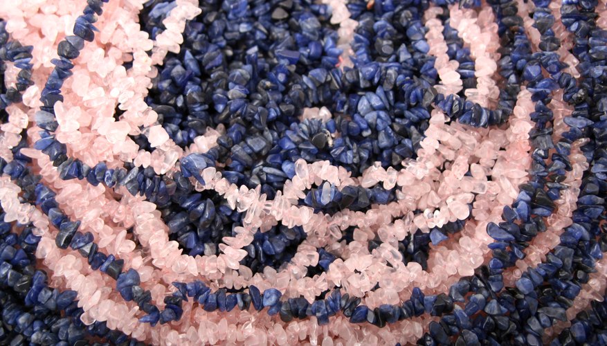 A close-up of rose quartz and blue lapis lazuli necklaces.