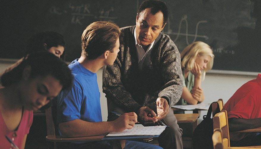 Teacher teaching student in classroom
