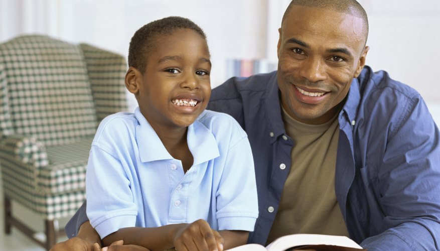Father reading Bible story to son.