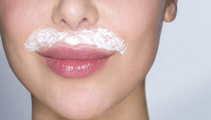 Smooth on a depilatory cream to target a peach fuzz mustache.