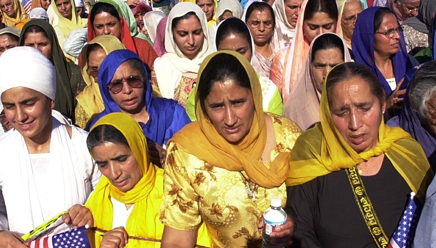 Sikh women, wearing traditional garb, practice a religion born in the 1500s.