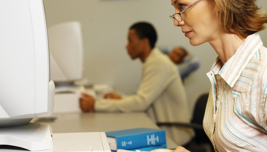Side profile of a woman working at a computer