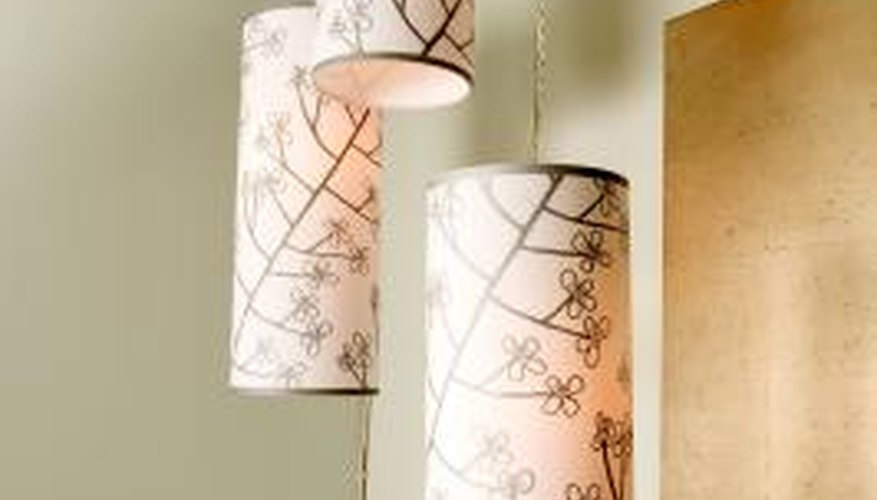 Round paper lampshades with ribbon trim at the top and bottom edges.