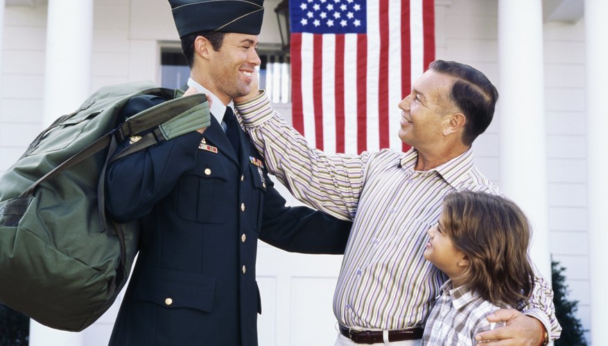 A proud family standing by a young man dressed in military uniform.