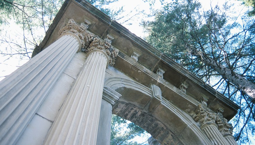 A high-angle view of ancient Greek pillars in the tree tops.