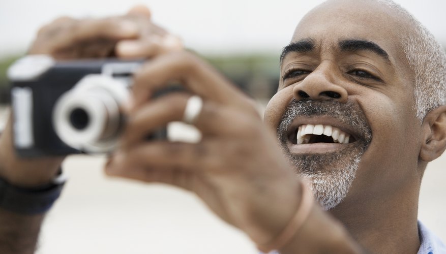 Man using a digital point and shoot camera.