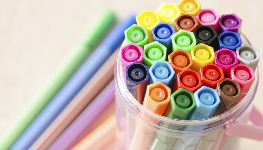 Markers stored in a plastic cup.