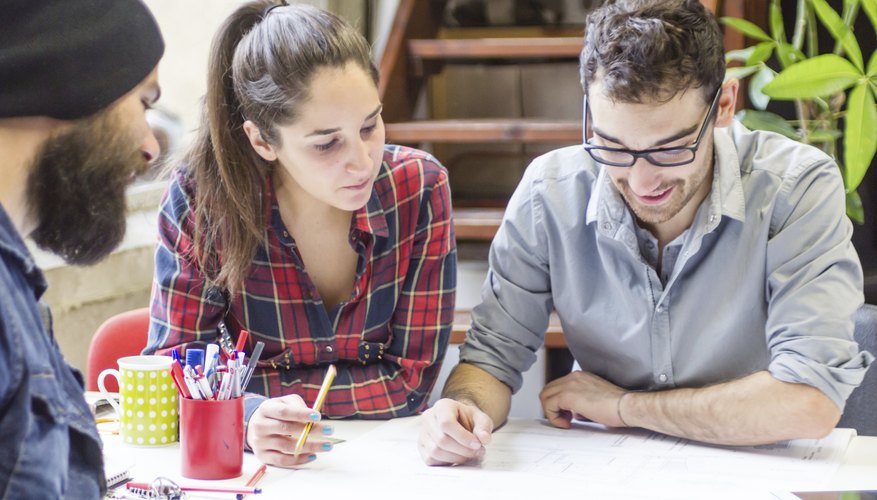 Three students working on a project together.