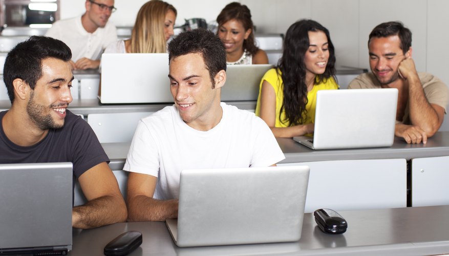 College students in class with their laptops