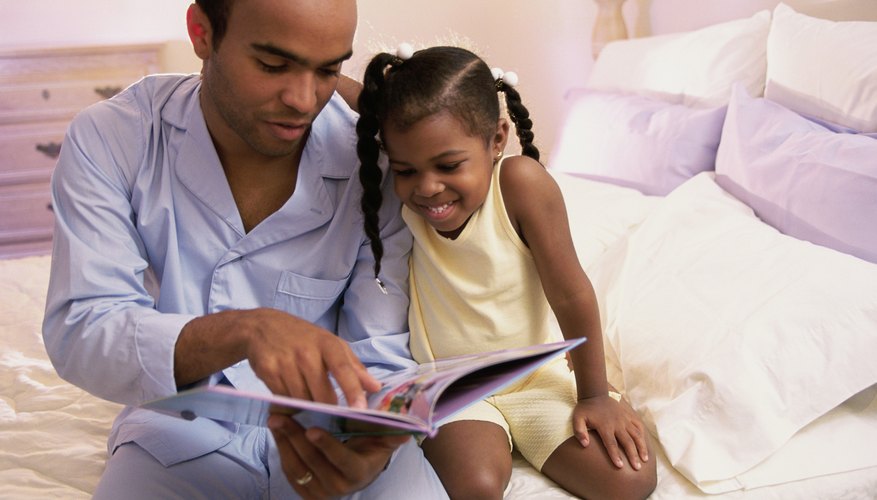 Child reading with father before bed.