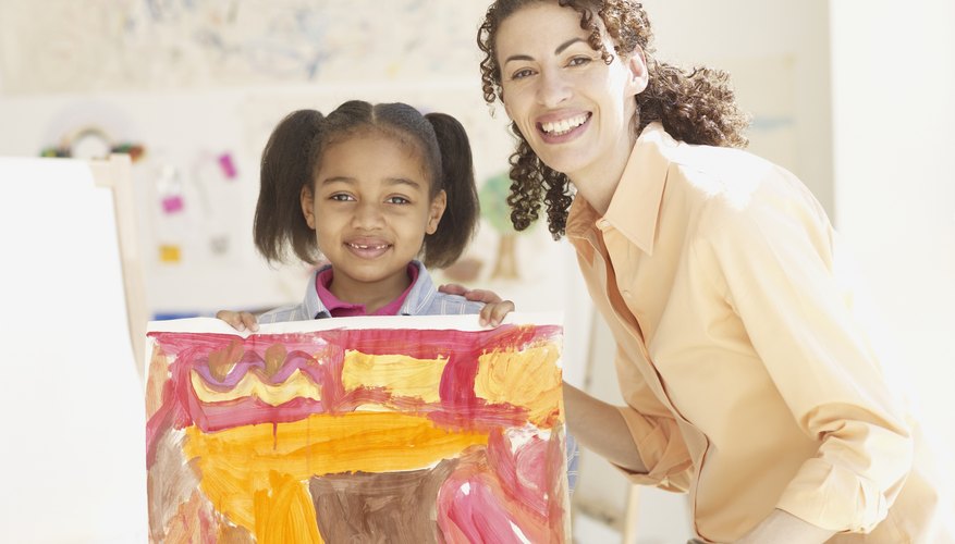 Smiling teacher next to young student