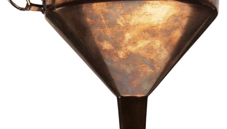 Photo Credit: Stockbyte/Stockbyte/Getty Images Metal funnel for oil.