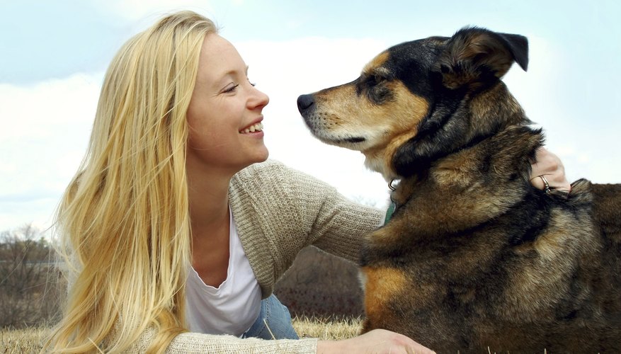 Woman and her German Shepherd outside.