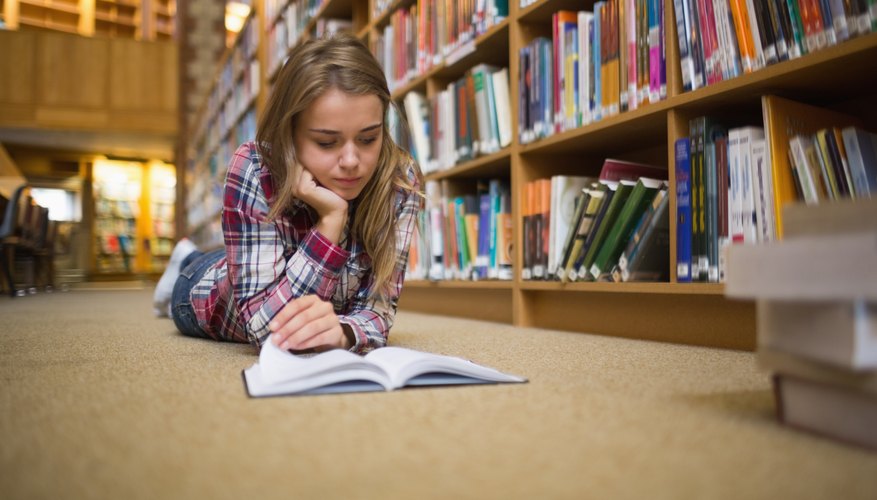 Student reading book in library.