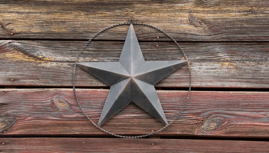 A close-up of an antique barn star on an old barn.