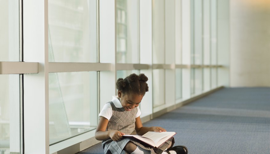 Young student reading in hallway