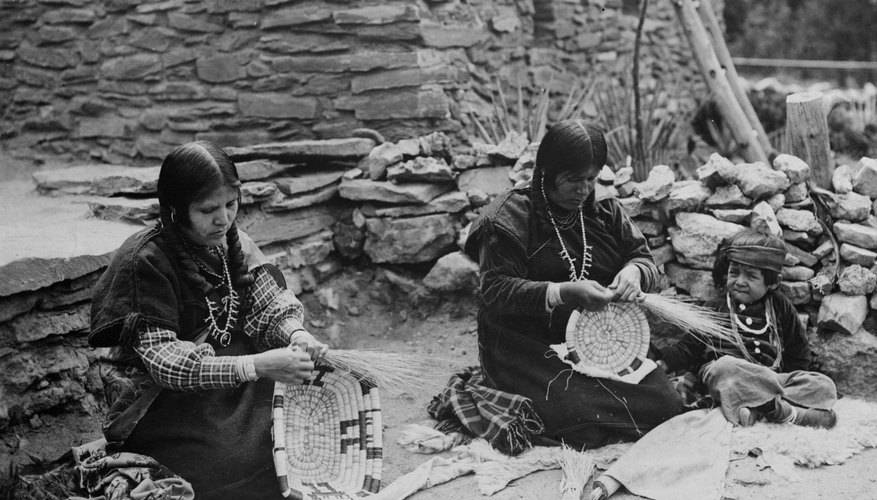 Two Hopis in a Nevada village weave baskets in 1937