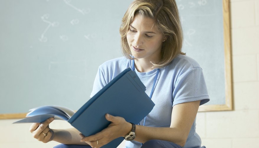 PE teacher looking at lesson plan