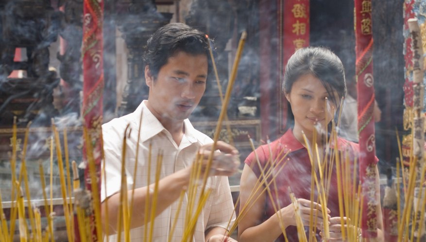 Offerings of incense, candles and flowers are made during the wedding ceremony.
