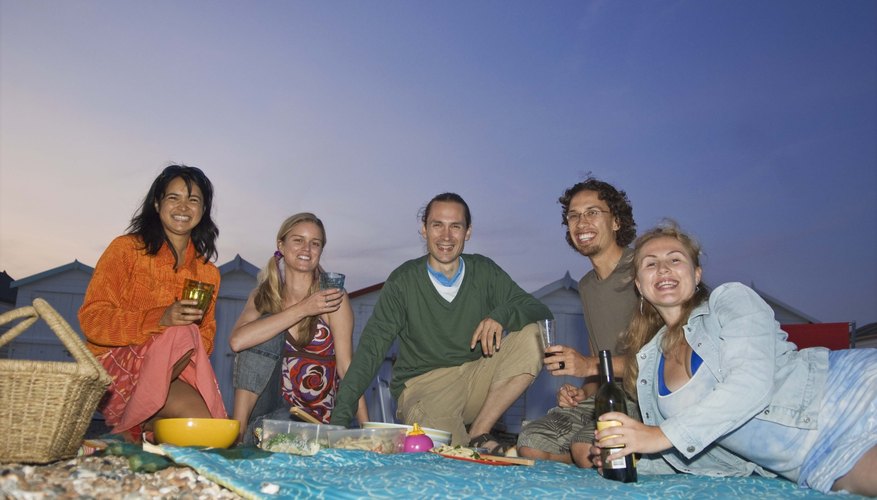 Reconnect with friends at an evening picnic on the beach.