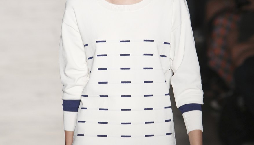 A model walking the runway in a Timeo Weiland show wears a classic drop-waist dress