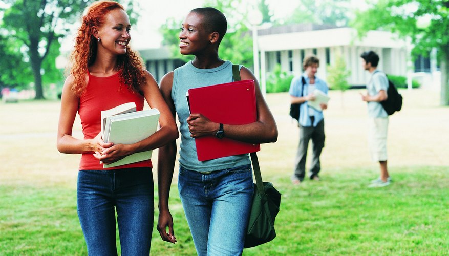 Smiling college students walking through campus