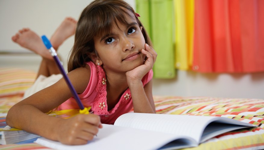 Child writing in notebook.