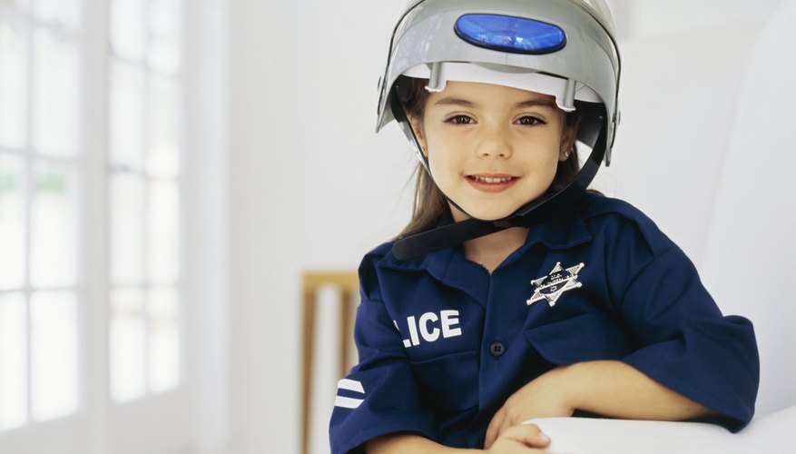A young girl dressed up as a police officer.