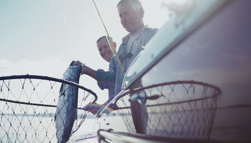 Photo Credit: Ryan McVay/Photodisc/Getty Images Two men fishing from boat