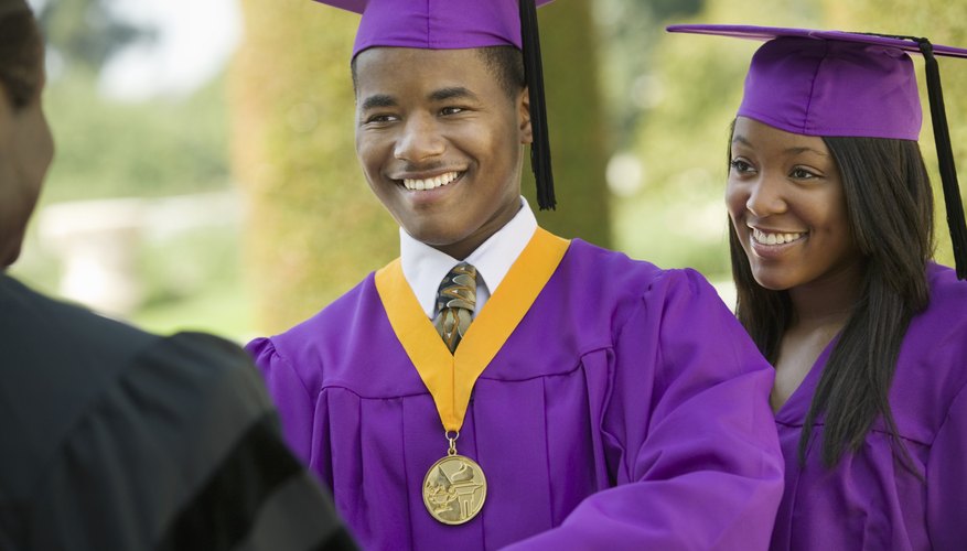 Young man receiving an award upon graduation.