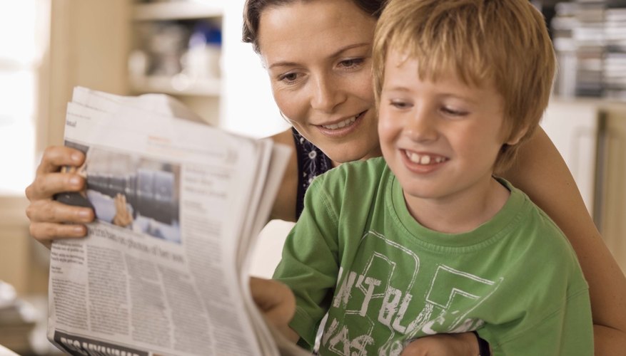 Mother and son looking at newspaper