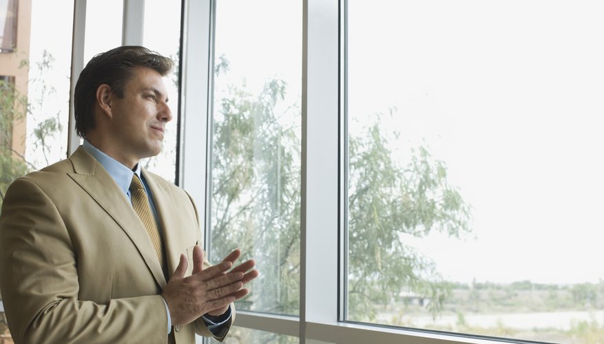 A businessman is looking out the window.