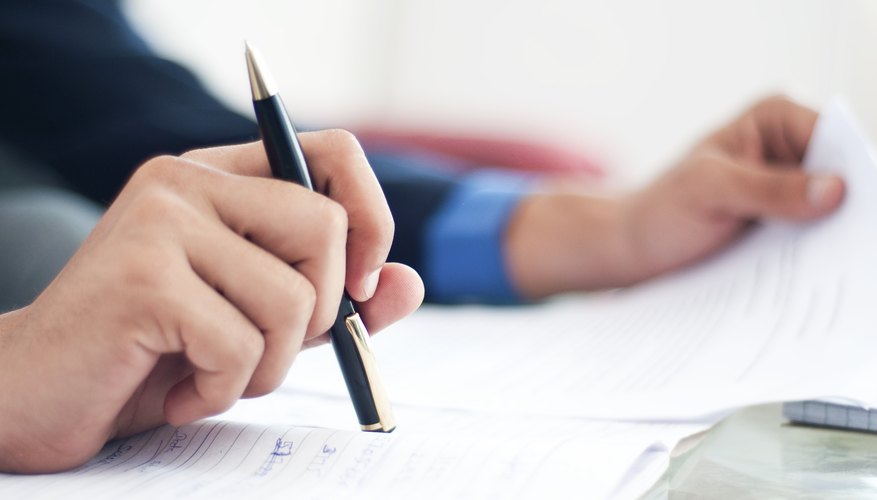 Close-up of man filling out paperwork