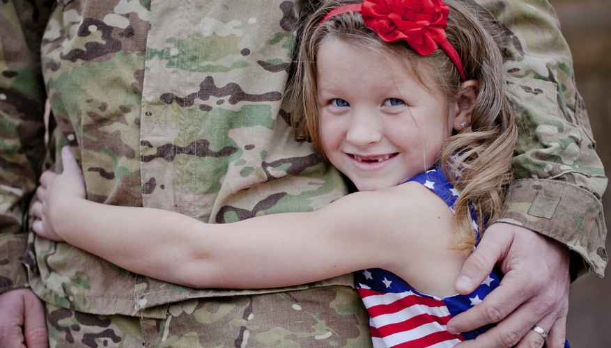 Little girl hugging soldier