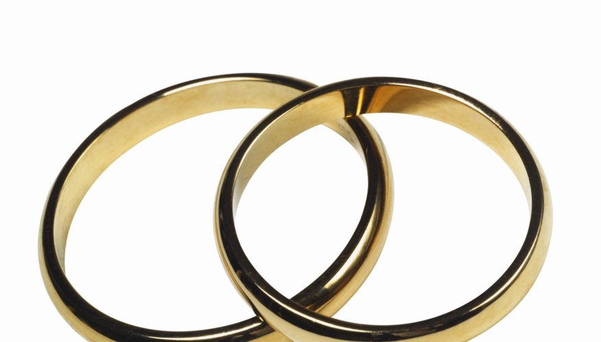 Wedding rings are worn on the right hands of the bride and groom.