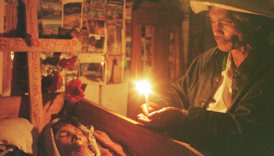 An Ifugao man mourns the dead during a customary three-day wake.