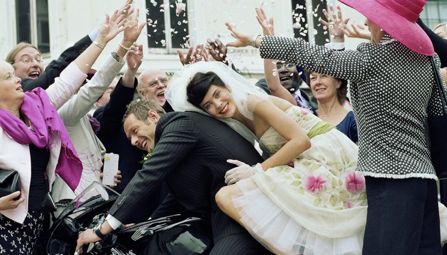 Nothing stands between bride and groom, but they are among a group.