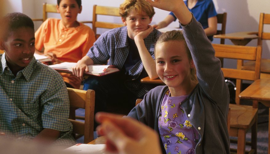 Student raising hand in classroom