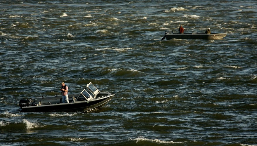 Photo Credit: Craig Mitchelldyer/Getty Images News/Getty Images Men fish from boats on choppy Columbia River