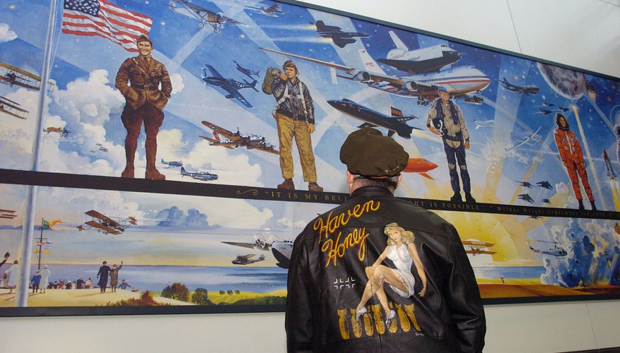 Man admires giant mural about the birth of flight