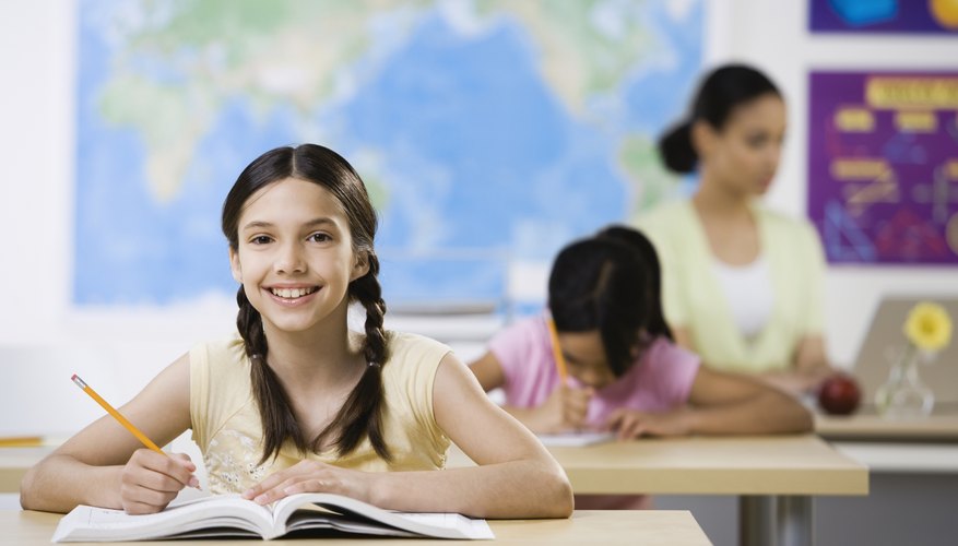Smiling student at desk in classroom