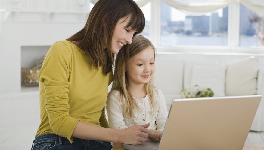 Mother and daughter using laptop