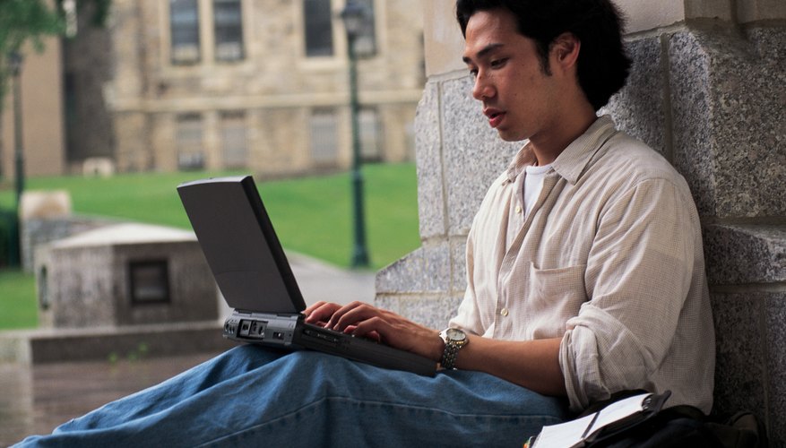 Student typing letter on laptop